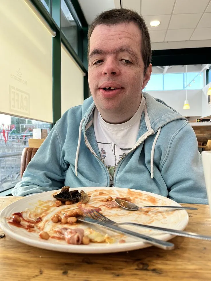Client smiling after finishing a meal at a café