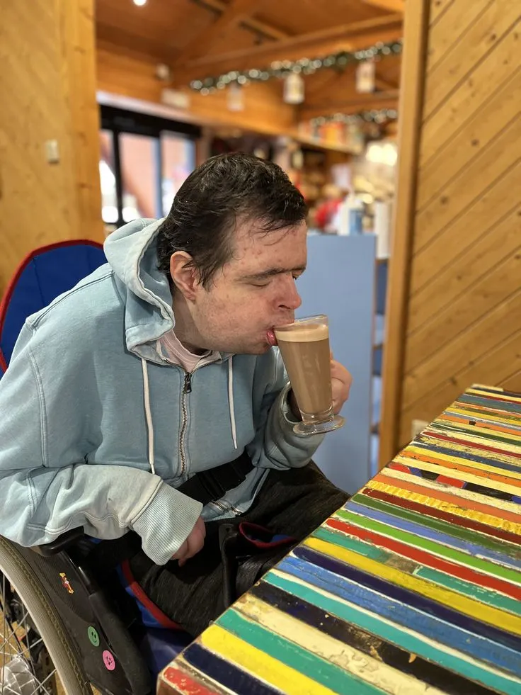 Client enjoying a hot chocolate at a wooden café
